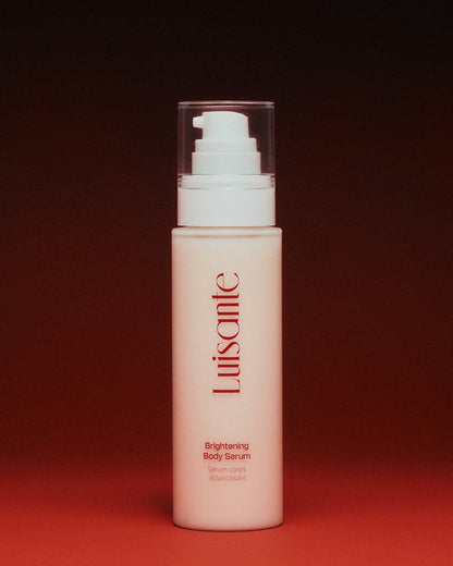Luisante brightening body serum in a white pump bottle with red logo on a red background